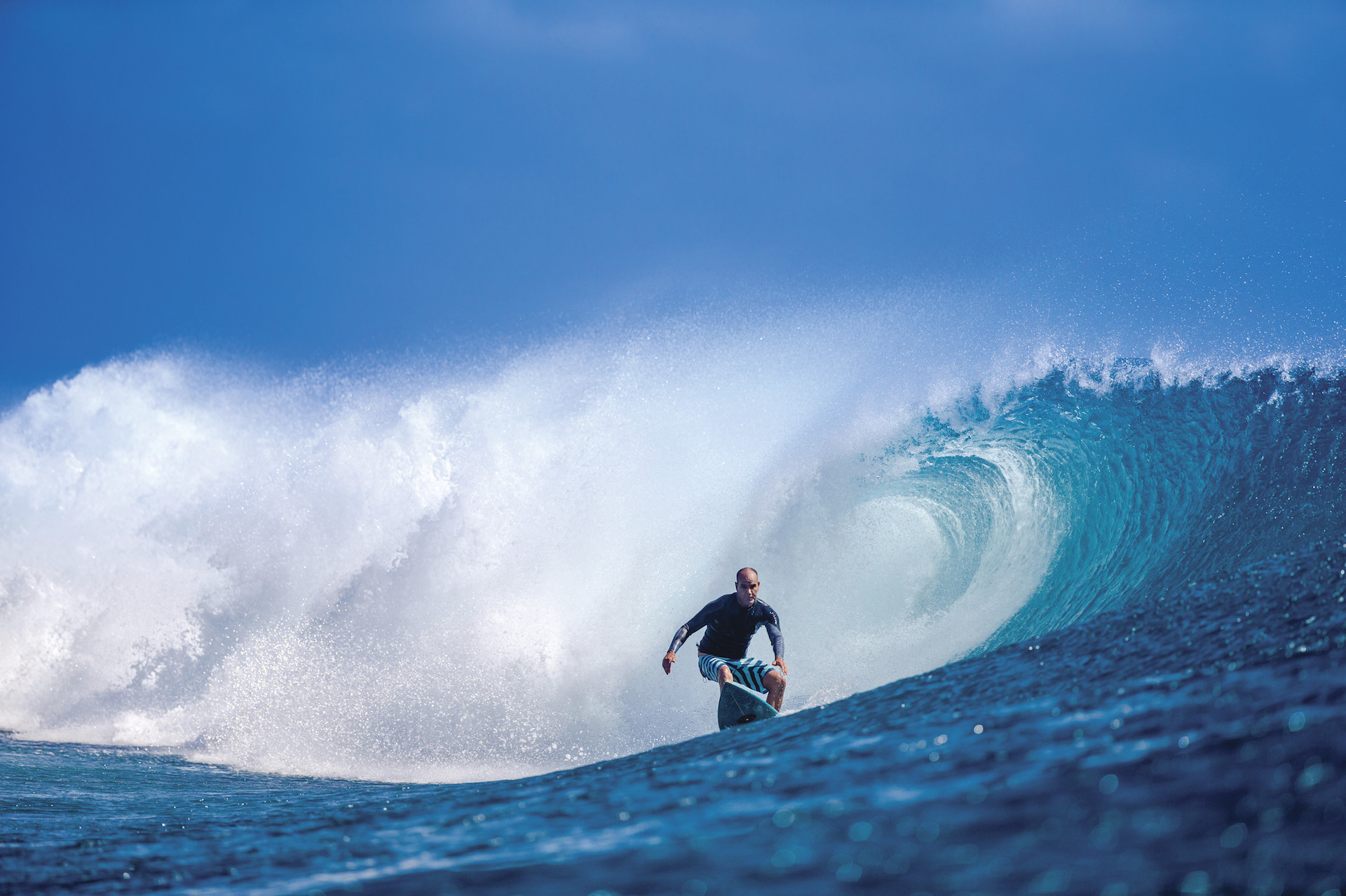 Lone surfer exiting barrel at Cloudbreak, Fiji